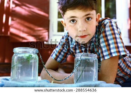 preteen handsome boy make an outdoor chemical test with carbonated water and cristal growth