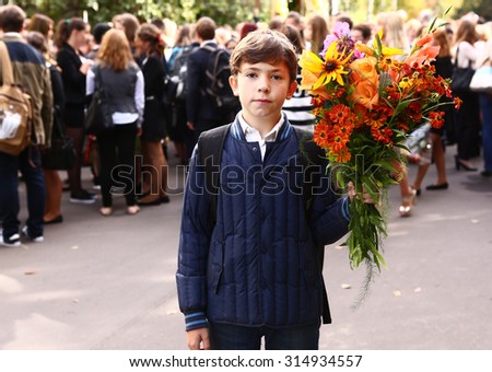 MOSCOW, SEPTEMBER 1, 2015: Unidentified boy with flowers celebrate first school day at September 1, Moscow.