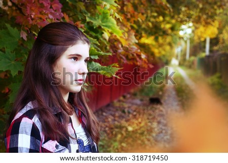 teen girl sad portrait on the autumn fall background