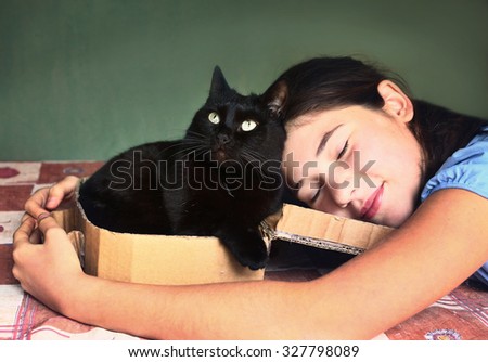 teen  girl and black cat in cardboard box