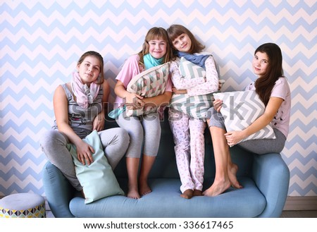 teen four girls on pajama party with pillows