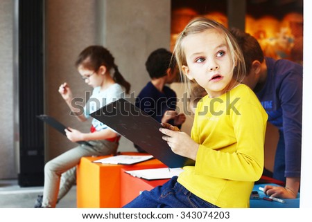 MOSCOW, NOVEMBER 22, 2015: Unidentified girl has drawing lesson with coal and white pastel in special art center for creative activity in Moscow, November 22