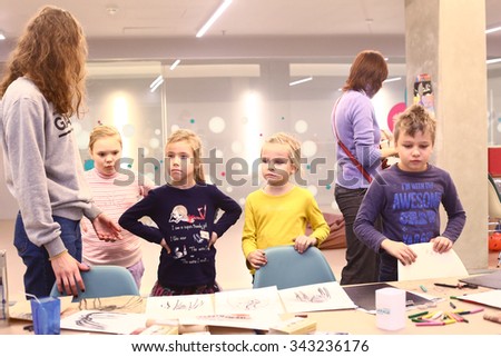 MOSCOW, NOVEMBER 22, 2015: Unidentified kids have drawing lesson with coal and white pastel in special art center for creative activity in Moscow, November 22