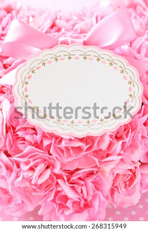 Blank card with pink bow ,beautiful pink carnations background