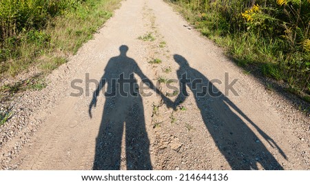 Theater of shadows boy and girl on rural path in summer day