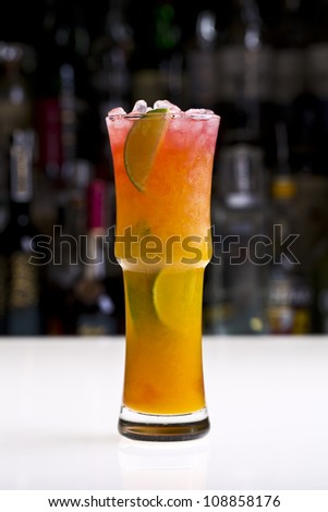 long drink / strawberry and mango cocktail with limes and crushed ice
