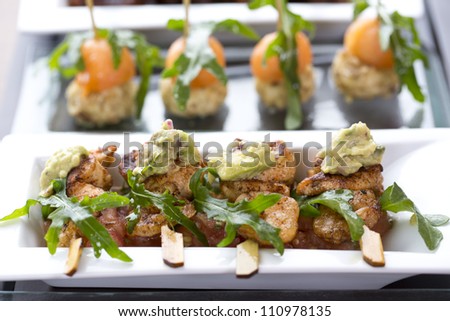 appetizer or tapas / chicken tapas with rocket salad on sticks
