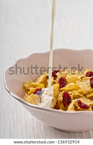corn flakes with cranberry and milk breakfast