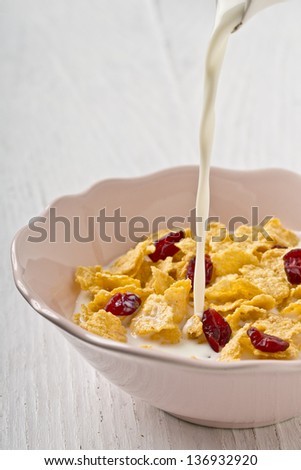 corn flakes with cranberry and milk breakfast