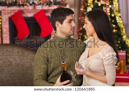 Couple at home in christmas night they\'re looking at each other