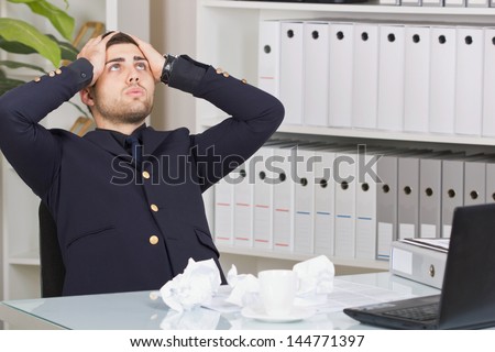 Senior business person  sitting at office desk looking up and being frustrated  from too much work