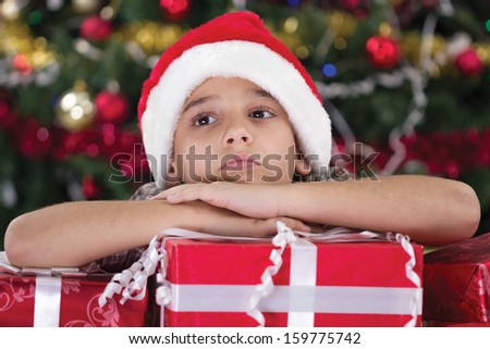 caucasian boy dreaming about presents at christmas time
