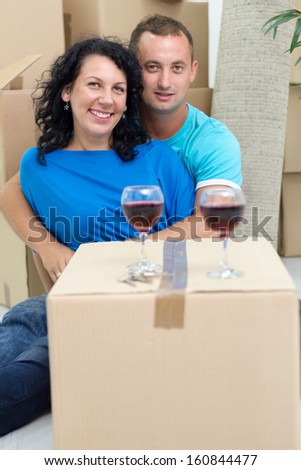 couple in their new home with cardboard boxes around