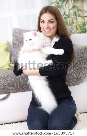 young woman holding a Persian cat