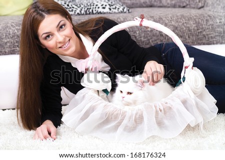 woman lying on the floor at home with Persian cat