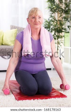 senior woman exercise with weights  at home