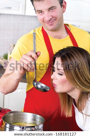 women testing the food prepared by they husband at home