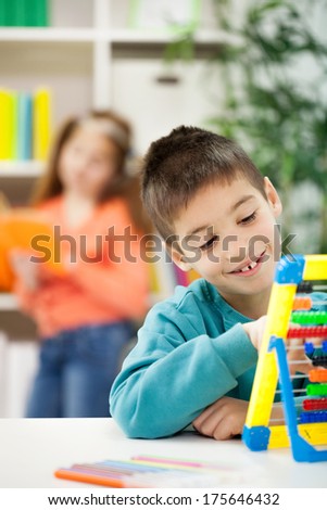 smiling young boy at home learning