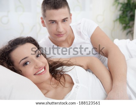 Young man and woman in bed