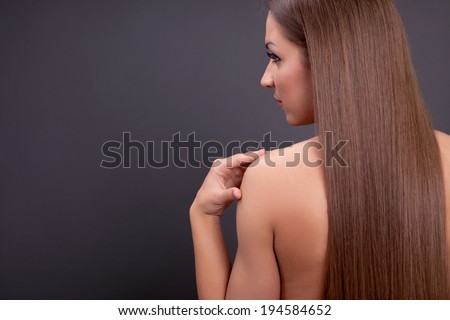 Beautiful back of a young woman with long brown hair