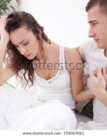 unhappy young  couple in bedroom under stress