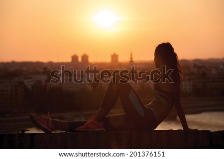 young Sports woman enjoying in the sunset after a hard workout