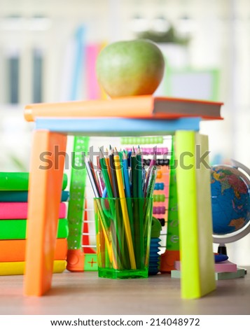 Globe, notebook stack and pencils. Schoolchild and student studies accessories