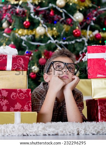 imagined boy with glasses in  New Year's Eve with  box gifts