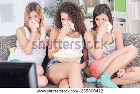 three beautiful young girls  watching sad movie depressed