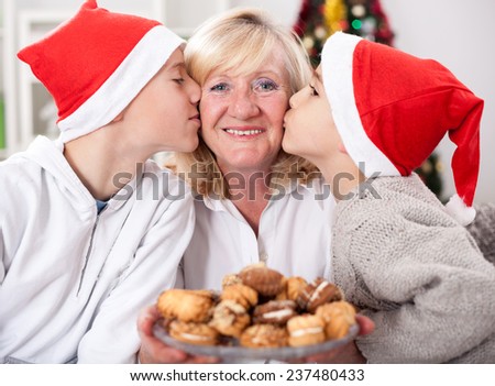happy granny and grandsons with cookies in Christmas night