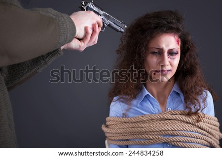 terrorists holding a gun to a woman\'s head