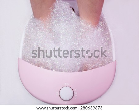 women is washing his foot to prepare for beauty treatment