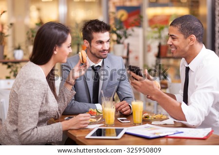 Three Business people Having Meeting In Outdoor Restaurant