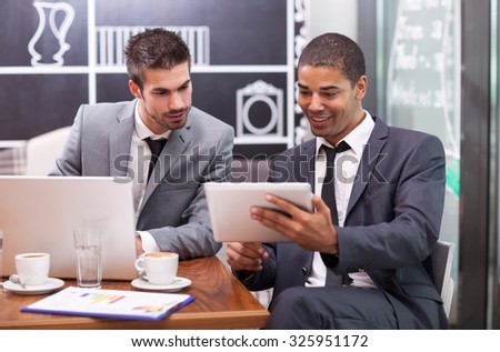 two businessman on a break in a cafe thinking about future actions