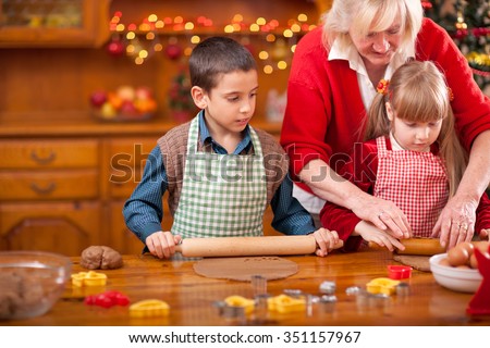 grandchildren and  grandmother baking Christmas cookies