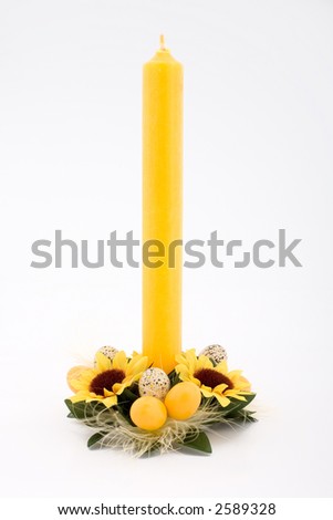 Easter candle with eggs and flowers