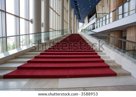 big marble stairs with red velvet