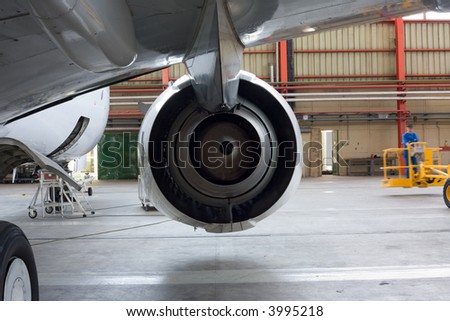 Jet engine at aircraft in the hangar, back  view