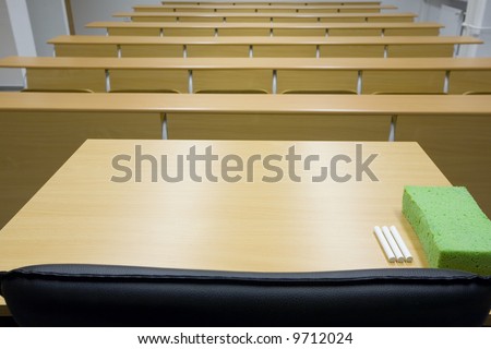 empty classroom, focus on the teacher desk