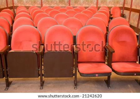 red chairs in the empty small cinema auditorium