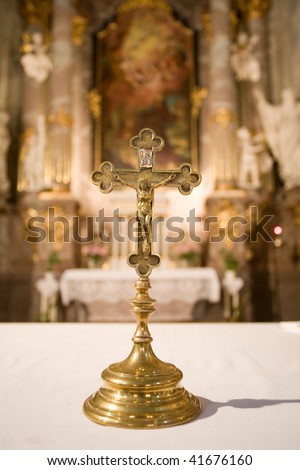 Interior of a catholic church with gold cross