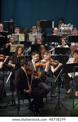 BUDAPEST - MARCH 6: Members of the MAV  Symphonic Orchestra perform on stage at Thalia Theater on March 06, 2010 in Budapest, Hungary.
