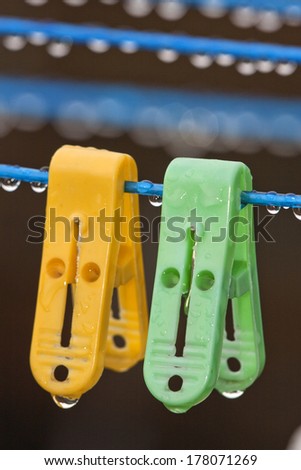 Clothes peg with water drops after rain