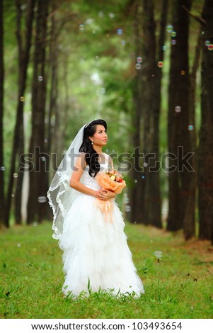 Asian bride with flower in forest scene