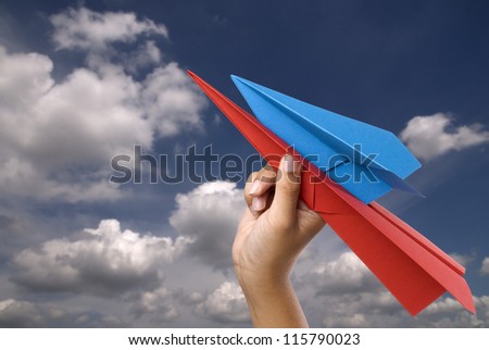 Sky with white clouds and paper airplane.