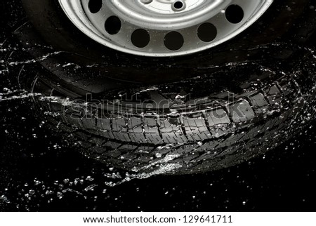 Car tire splashing in water, Tire with water.