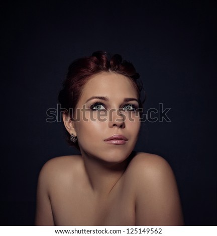 Portrait of a beautiful woman on dark background