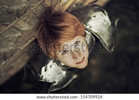 Portrait of a medieval female knight in armour outdoor