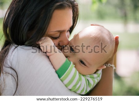 Happy mother lay with newborn baby