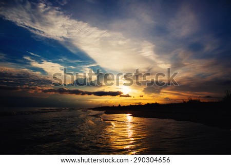 Dramatic cloudy sunset on the beach in Ukraine